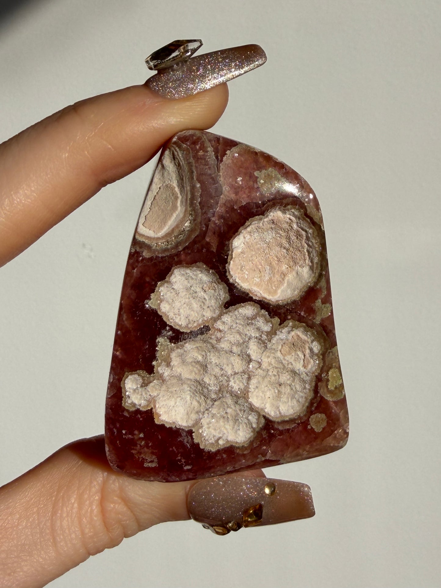 “Luminance” Gemmy Gel Rhodochrosite Freeform with Copper Inclusions