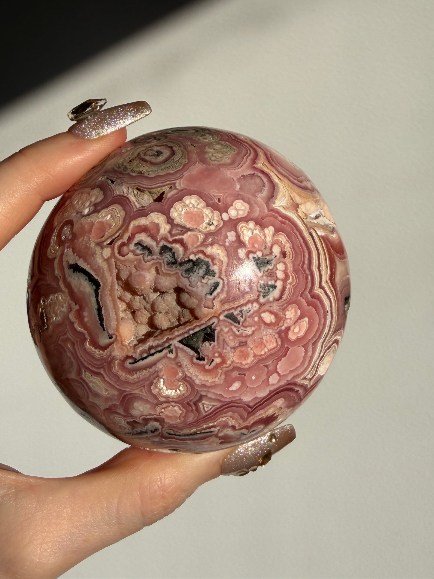 “Rosen Blooms” Floral Banded Rhodochrosite Sphere A